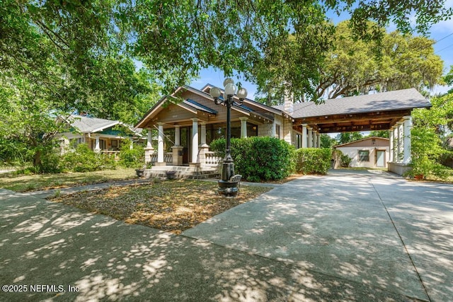 4215 Irvington Ave, Jacksonville, FL 32210 - craftsman-style house with a chimney, covered porch, and concrete driveway