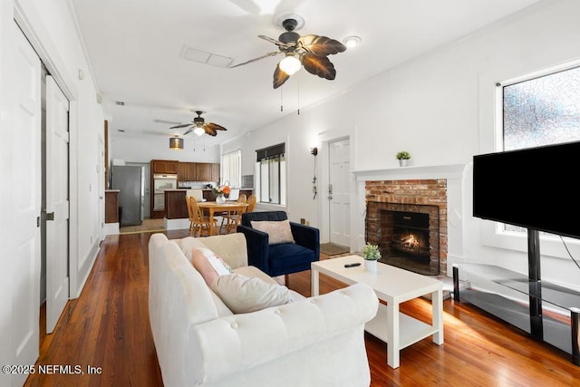 4215 Irvington Ave, Jacksonville, FL 32210 - living room featuring dark wood-style flooring, a fireplace, and a ceiling fan