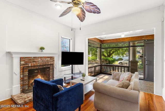 4215 Irvington Ave, Jacksonville, FL 32210 - living room featuring a brick fireplace, wood finished floors, and ceiling fan