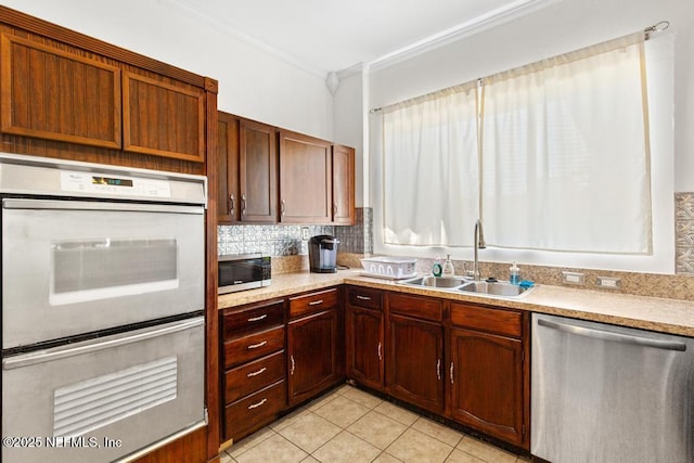 4215 Irvington Ave, Jacksonville, FL 32210 - kitchen featuring light countertops, crown molding, light tile patterned flooring, stainless steel appliances, and a sink