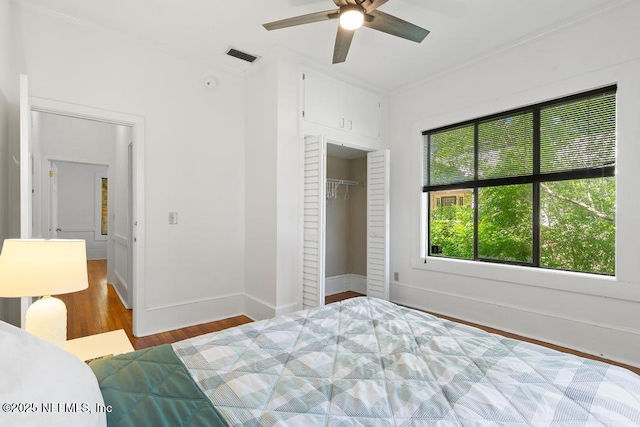 4215 Irvington Ave, Jacksonville, FL 32210 - bedroom featuring a closet, ornamental molding, visible vents, wood finished floors, and baseboards