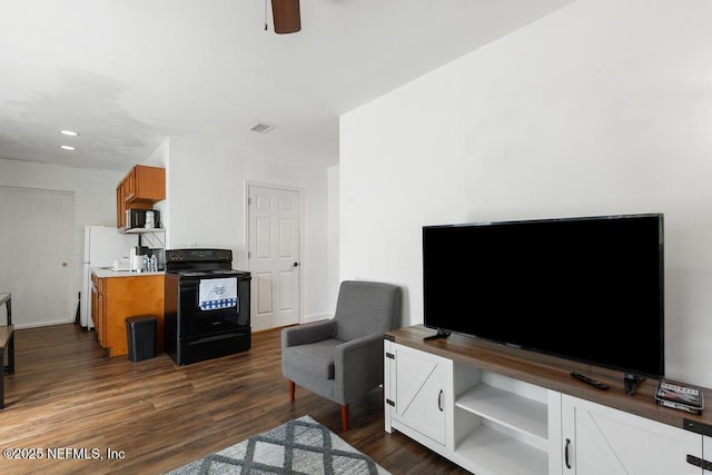 4215 Irvington Ave, Jacksonville, FL 32210 - living area with ceiling fan, dark wood-style floors, and visible vents