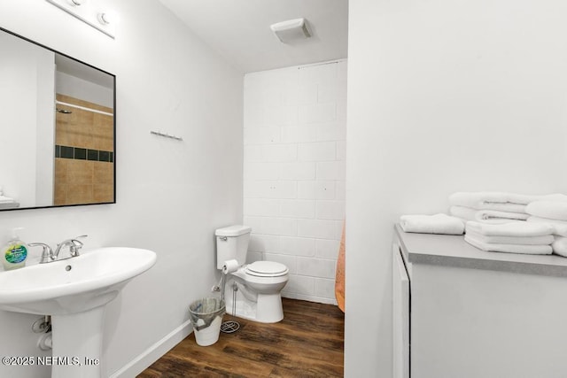 4215 Irvington Ave, Jacksonville, FL 32210 - full bath with baseboards, walk in shower, toilet, a sink, and wood finished floors
