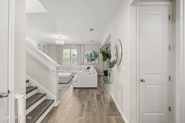 190 Palisade Dr, Saint Augustine, FL 32092 - interior space featuring stairway, wood finished floors, baseboards, a notable chandelier, and visible vents