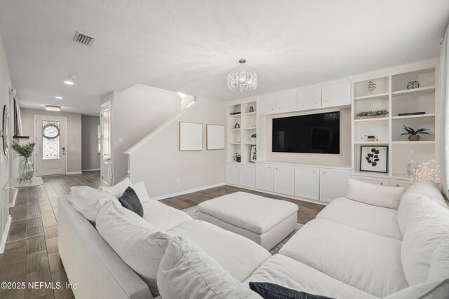 190 Palisade Dr, Saint Augustine, FL 32092 - living area featuring a chandelier, visible vents, baseboards, and dark wood-style flooring