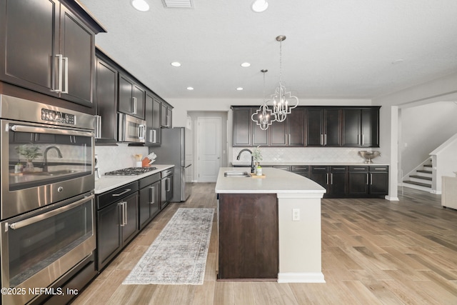 190 Palisade Dr, Saint Augustine, FL 32092 - kitchen featuring recessed lighting, light countertops, decorative backsplash, a kitchen island with sink, and appliances with stainless steel finishes