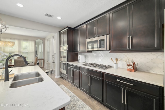 190 Palisade Dr, Saint Augustine, FL 32092 - kitchen featuring stainless steel appliances, visible vents, a sink, and tasteful backsplash