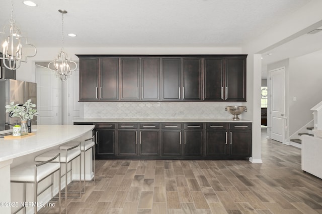 190 Palisade Dr, Saint Augustine, FL 32092 - kitchen with backsplash, freestanding refrigerator, light countertops, and a notable chandelier