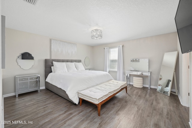 190 Palisade Dr, Saint Augustine, FL 32092 - bedroom with baseboards, wood finished floors, and an inviting chandelier