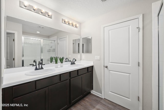 190 Palisade Dr, Saint Augustine, FL 32092 - full bath featuring wood finished floors, a sink, a shower stall, and double vanity