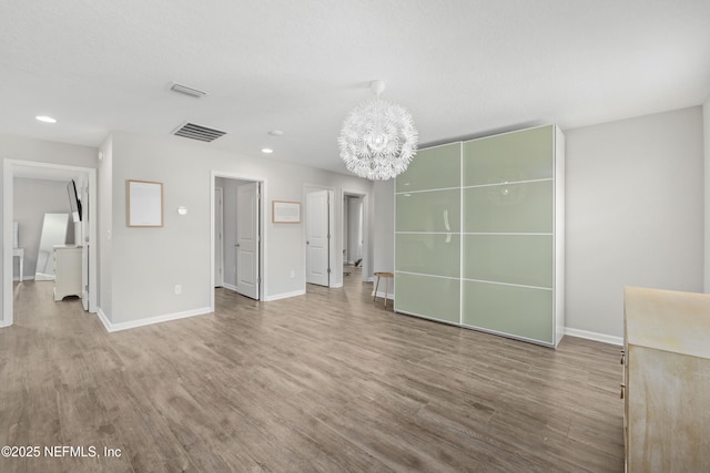 190 Palisade Dr, Saint Augustine, FL 32092 - unfurnished living room with wood finished floors, an inviting chandelier, baseboards, visible vents, and recessed lighting