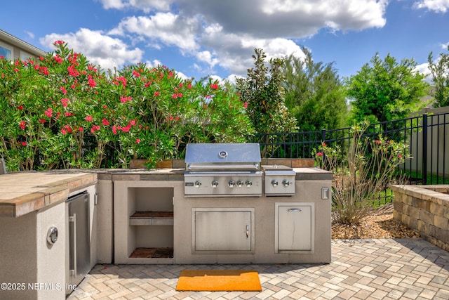 190 Palisade Dr, Saint Augustine, FL 32092 - view of patio / terrace featuring fence, an outdoor kitchen, and area for grilling