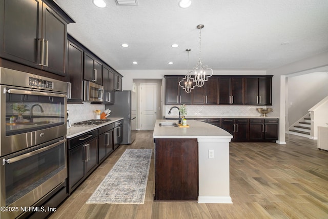 190 Palisade Dr, Saint Augustine, FL 32092 - kitchen featuring dark brown cabinetry, light countertops, backsplash, appliances with stainless steel finishes, and recessed lighting