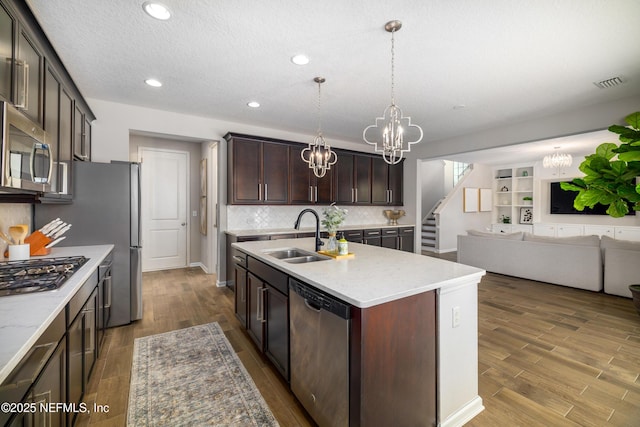 190 Palisade Dr, Saint Augustine, FL 32092 - kitchen featuring stainless steel appliances, open floor plan, a sink, and a notable chandelier
