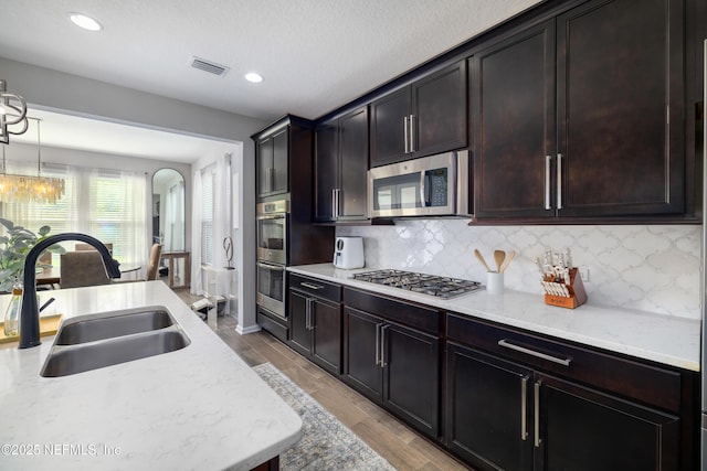 190 Palisade Dr, Saint Augustine, FL 32092 - kitchen with decorative backsplash, appliances with stainless steel finishes, a sink, and visible vents