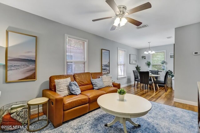 2969 Green St, Jacksonville, FL 32205 - living area with visible vents, baseboards, ceiling fan with notable chandelier, and wood finished floors