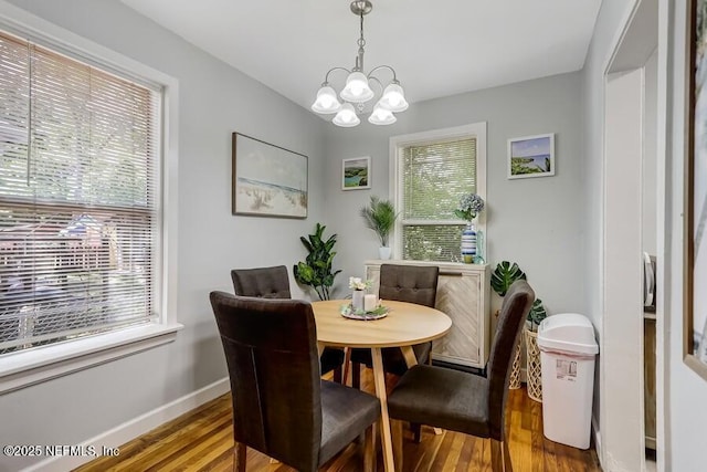 2969 Green St, Jacksonville, FL 32205 - dining space with baseboards, wood finished floors, a notable chandelier, and plenty of natural light