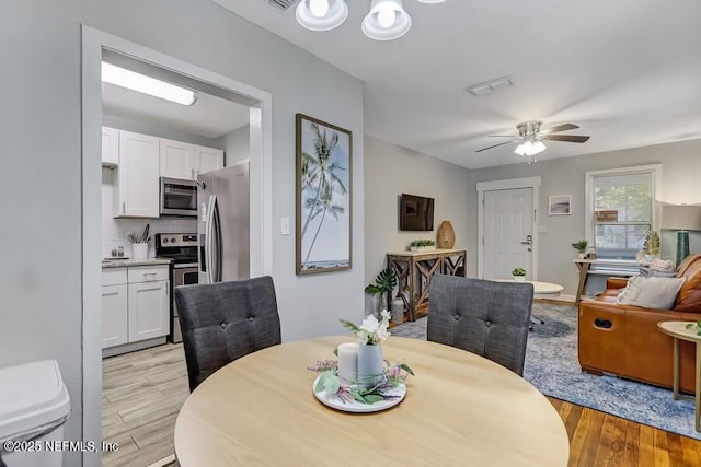 2969 Green St, Jacksonville, FL 32205 - dining space featuring visible vents, light wood-style flooring, and a ceiling fan