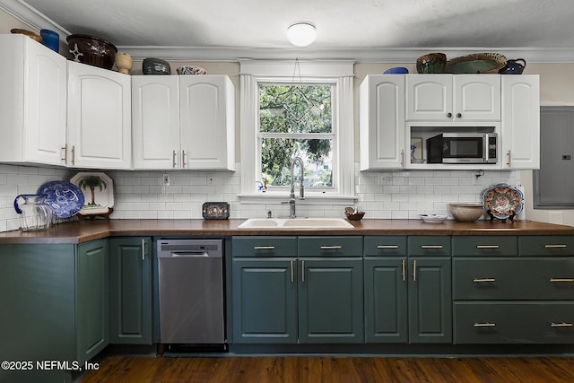 73 Weeden St, Saint Augustine, FL 32084 - kitchen with stainless steel appliances, white cabinets, a sink, and dark countertops