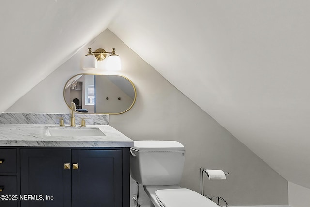 73 Weeden St, Saint Augustine, FL 32084 - bathroom with toilet, vanity, and lofted ceiling