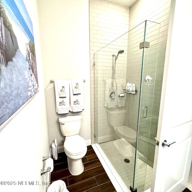 273 Caribbean Pl, Saint Johns, FL 32259 - bathroom with toilet, wood tiled floors, a shower stall, and baseboards
