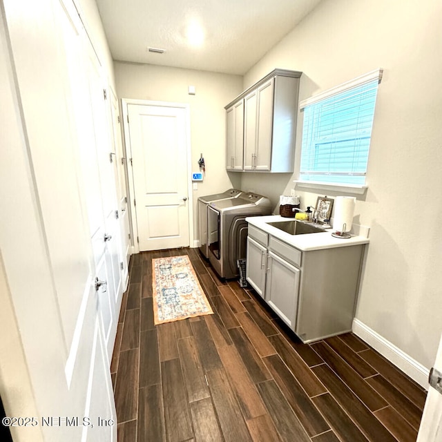273 Caribbean Pl, Saint Johns, FL 32259 - laundry area featuring cabinet space, baseboards, wood finish floors, and washing machine and dryer