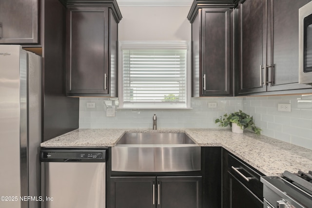 58 Strobe Ct, Saint Augustine, FL 32095 - kitchen featuring appliances with stainless steel finishes, a sink, tasteful backsplash, and dark brown cabinetry