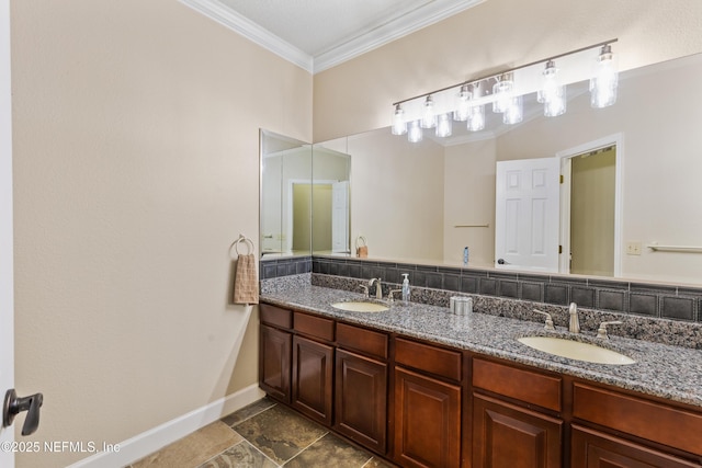 full bath with double vanity, baseboards, a sink, and ornamental molding