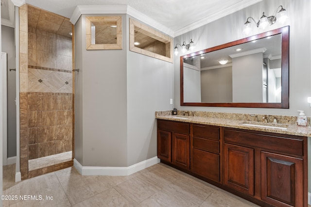 full bath featuring a sink, walk in shower, double vanity, baseboards, and ornamental molding