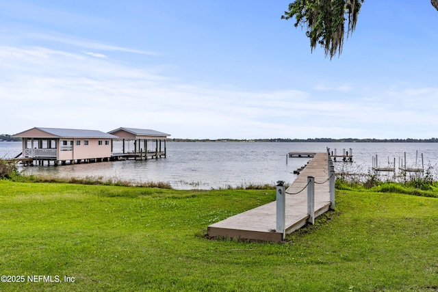 dock area featuring a lawn and a water view