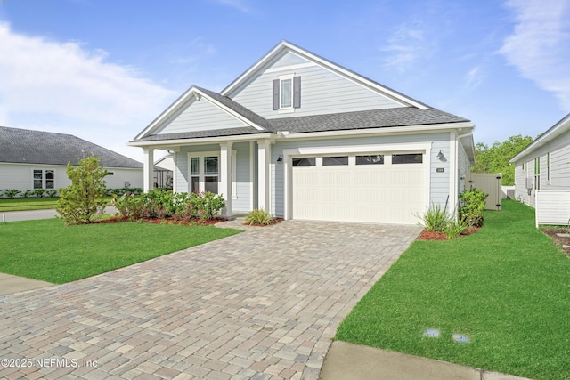 380 Maralinda Dr, Saint Augustine, FL 32095 - view of front of house featuring a front yard, a shingled roof, decorative driveway, and an attached garage