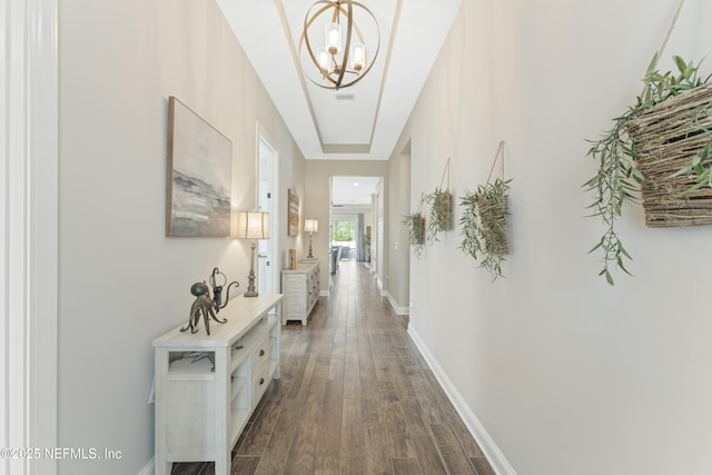 380 Maralinda Dr, Saint Augustine, FL 32095 - corridor featuring a notable chandelier, baseboards, and dark wood-style floors
