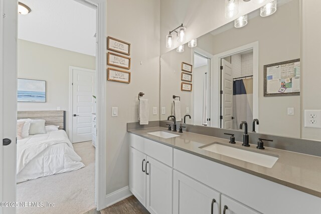380 Maralinda Dr, Saint Augustine, FL 32095 - ensuite bathroom with double vanity, a sink, baseboards, and connected bathroom