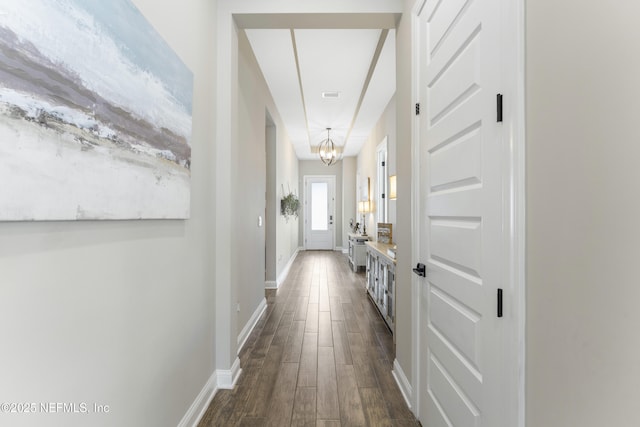 380 Maralinda Dr, Saint Augustine, FL 32095 - hall featuring dark wood-style flooring, baseboards, and an inviting chandelier