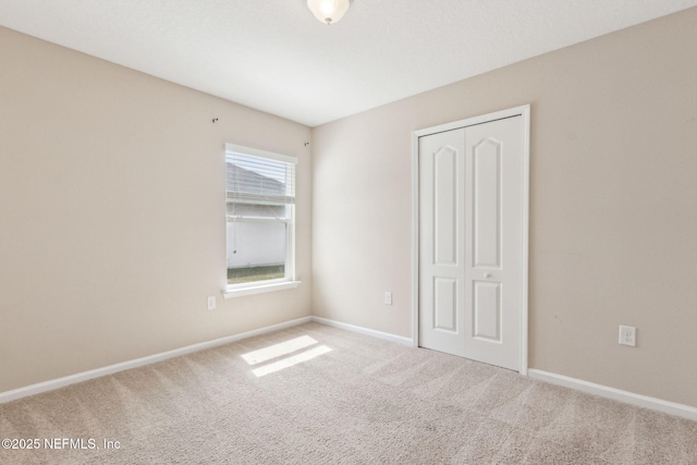 95210 Leafcrest Ct, Fernandina Beach, FL 32034 - unfurnished bedroom featuring baseboards, carpet floors, and a closet