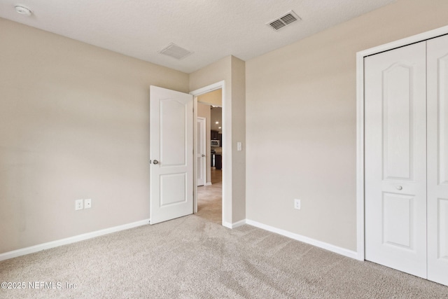 95210 Leafcrest Ct, Fernandina Beach, FL 32034 - unfurnished bedroom with baseboards, visible vents, and carpet