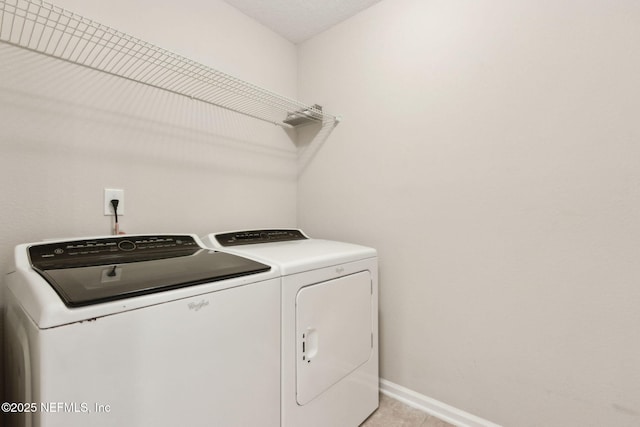 95210 Leafcrest Ct, Fernandina Beach, FL 32034 - washroom with washing machine and clothes dryer, baseboards, laundry area, and light tile patterned flooring