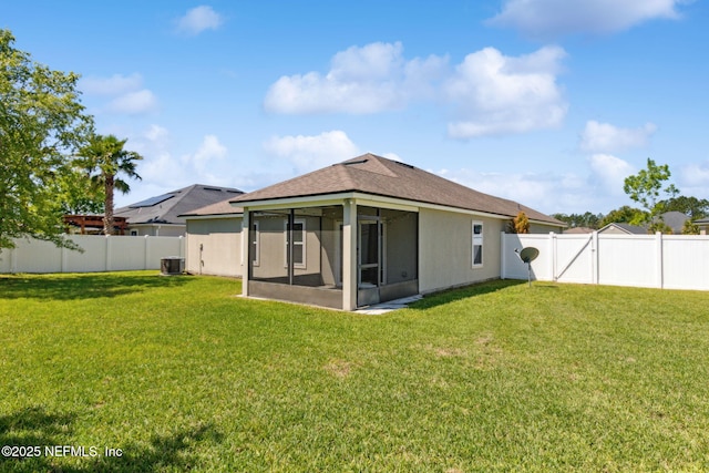 95210 Leafcrest Ct, Fernandina Beach, FL 32034 - rear view of property with stucco siding, a lawn, a sunroom, and central AC unit
