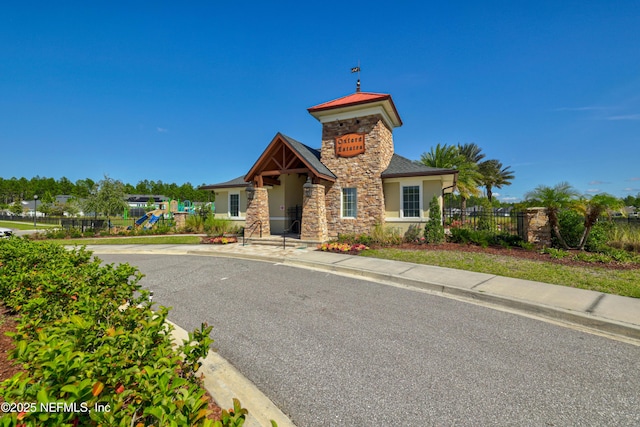 121 Oxford Estates Way, Saint Johns, FL 32259 - view of front of property with a playground, stone siding, stucco siding, and fence