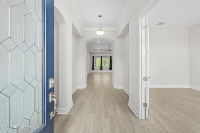 121 Oxford Estates Way, Saint Johns, FL 32259 - entrance foyer with arched walkways, ceiling fan, baseboards, light wood-type flooring, and crown molding