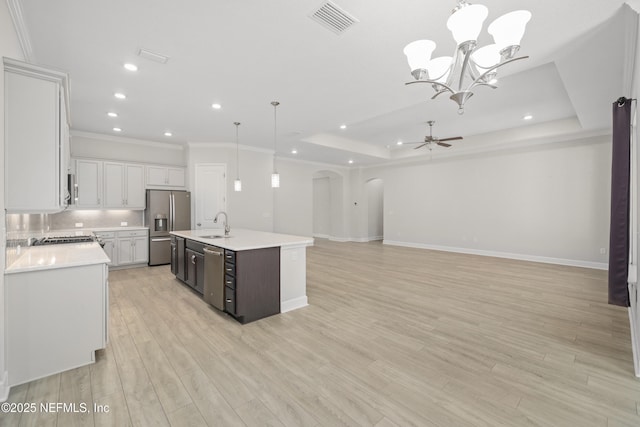 121 Oxford Estates Way, Saint Johns, FL 32259 - kitchen featuring arched walkways, appliances with stainless steel finishes, light countertops, ceiling fan with notable chandelier, and visible vents