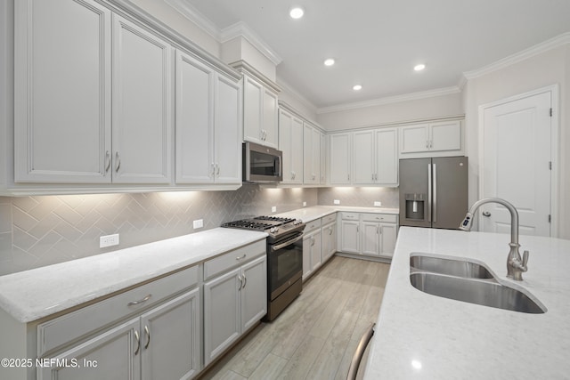 121 Oxford Estates Way, Saint Johns, FL 32259 - kitchen featuring recessed lighting, a sink, crown molding, light wood-style flooring, and appliances with stainless steel finishes