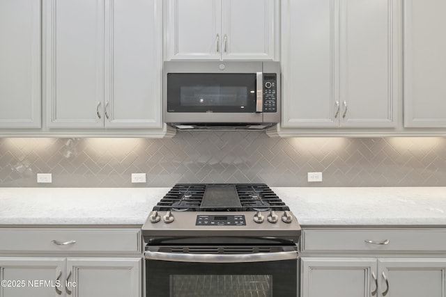 121 Oxford Estates Way, Saint Johns, FL 32259 - kitchen with white cabinetry, tasteful backsplash, and stainless steel appliances