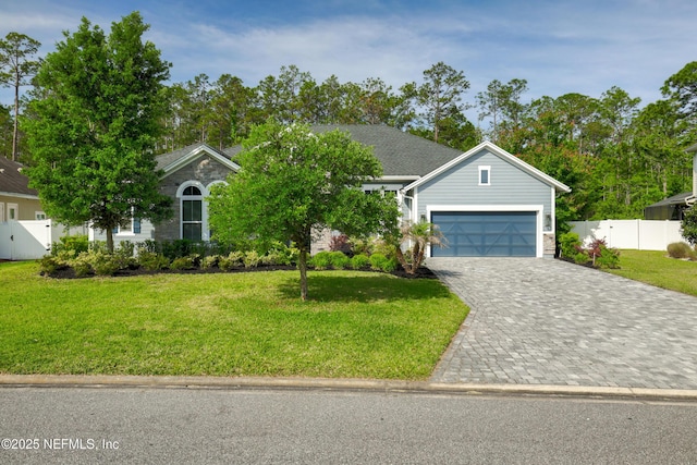 121 Oxford Estates Way, Saint Johns, FL 32259 - view of front of home with fence, decorative driveway, an attached garage, and a front lawn
