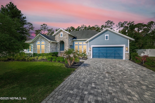 121 Oxford Estates Way, Saint Johns, FL 32259 - view of front of house with fence, decorative driveway, a garage, stone siding, and a front yard
