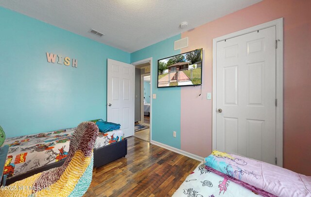 8413 Free Ave, Jacksonville, FL 32211 - bedroom featuring visible vents, baseboards, a textured ceiling, and wood finished floors