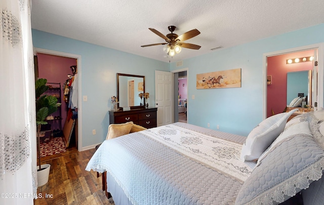 8413 Free Ave, Jacksonville, FL 32211 - bedroom featuring ceiling fan, visible vents, wood finished floors, a walk in closet, and baseboards