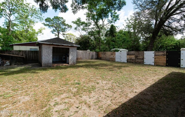 8413 Free Ave, Jacksonville, FL 32211 - view of yard with fence private yard, a gate, and an outbuilding