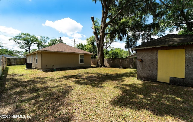 8413 Free Ave, Jacksonville, FL 32211 - view of yard with central AC unit, a fenced backyard, and an outbuilding