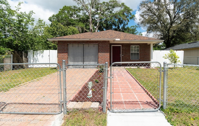 8413 Free Ave, Jacksonville, FL 32211 - view of front of house featuring brick siding, a gate, and a front lawn
